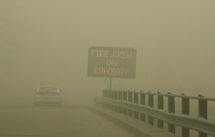 Because of poor visibility and health concerns, Elmore County sheriff's deputies issued mandatory evacuation orders to residents of Featherville, Idaho, as the Trinity Ridge fire continued to burn on Saturday, Aug. 18, 2012. (AP Photo/Idaho Statesman, Katherine Jones)
