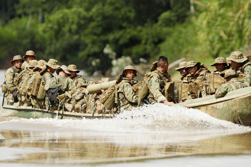 IPanama border police patrol by boat in the Darien province on the border with Colombia, near Yaviza, Panama. Panamanian authorities began noticing five years ago that the Darien Gap, the only interruption in the hemisphere-spanning Pan-American Highway, was being used by migrant smugglers, usually to move people from Asia and Africa. (AP Photo/Arnulfo Franco)