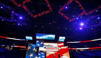 Republican National Committee Chairman Reince Priebus (left) and convention CEO William Harris on Monday unveil the stage for the 2012 Republican National Convention in Tampa, Fla. The 40-by-60 foot stage cost a reported $2.5 million. (Associated Press)