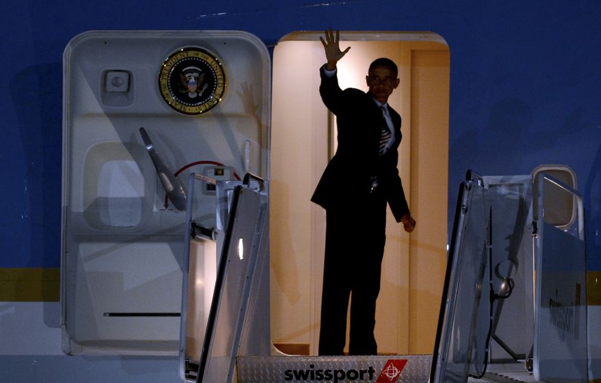 President Obama waves Aug. 6, 2012, as he boards Air Force One at John F. Kennedy International Airport in New York after attending two fundraisers in Connecticut. (Associated Press)