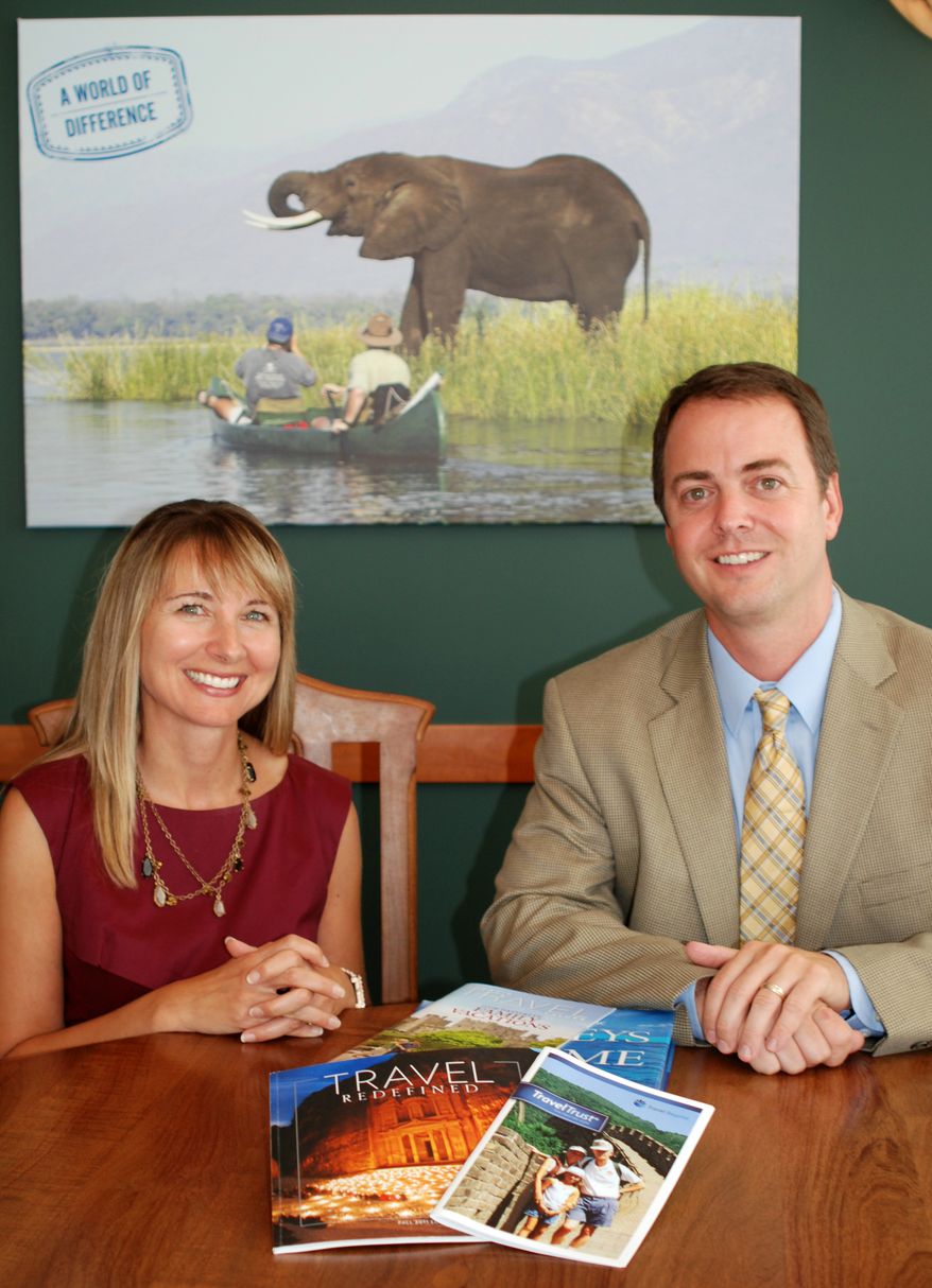 Margaret Cronin, a partner with the law firm Leonard, Street and Deinard, and Jim Bendt, president of Travel Beyond, are seen July 25, 2012, at Travel Beyond's Minneapolis offices. Travel Beyond, a travel agency, has partnered with the law firm to help clients plan trusts that fund travel as part of an inheritance. (Associated Press/Travel Beyond)