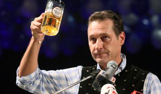 Heinz-Christian Strache, head of the Austrian right-wing Freedom Party, lifts a mug of beer during his traditional Ash Wednesday speech in Ried, Austria, on Wednesday, Feb. 22, 2012. (AP Photo/dapd, Rudolf Brandstaetter)