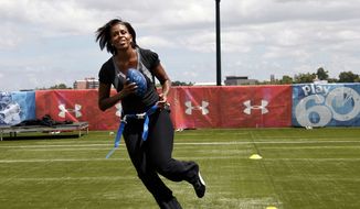 ** FILE ** First lady Michelle Obama turns and runs after catching a pass while participating in her &quot;Let&#39;s Move!&quot; campaign and the NFL&#39;s Play 60 campaign festivities with area youth in New Orleans on Sept. 8, 2010. (AP Photo/Gerald Herbert)