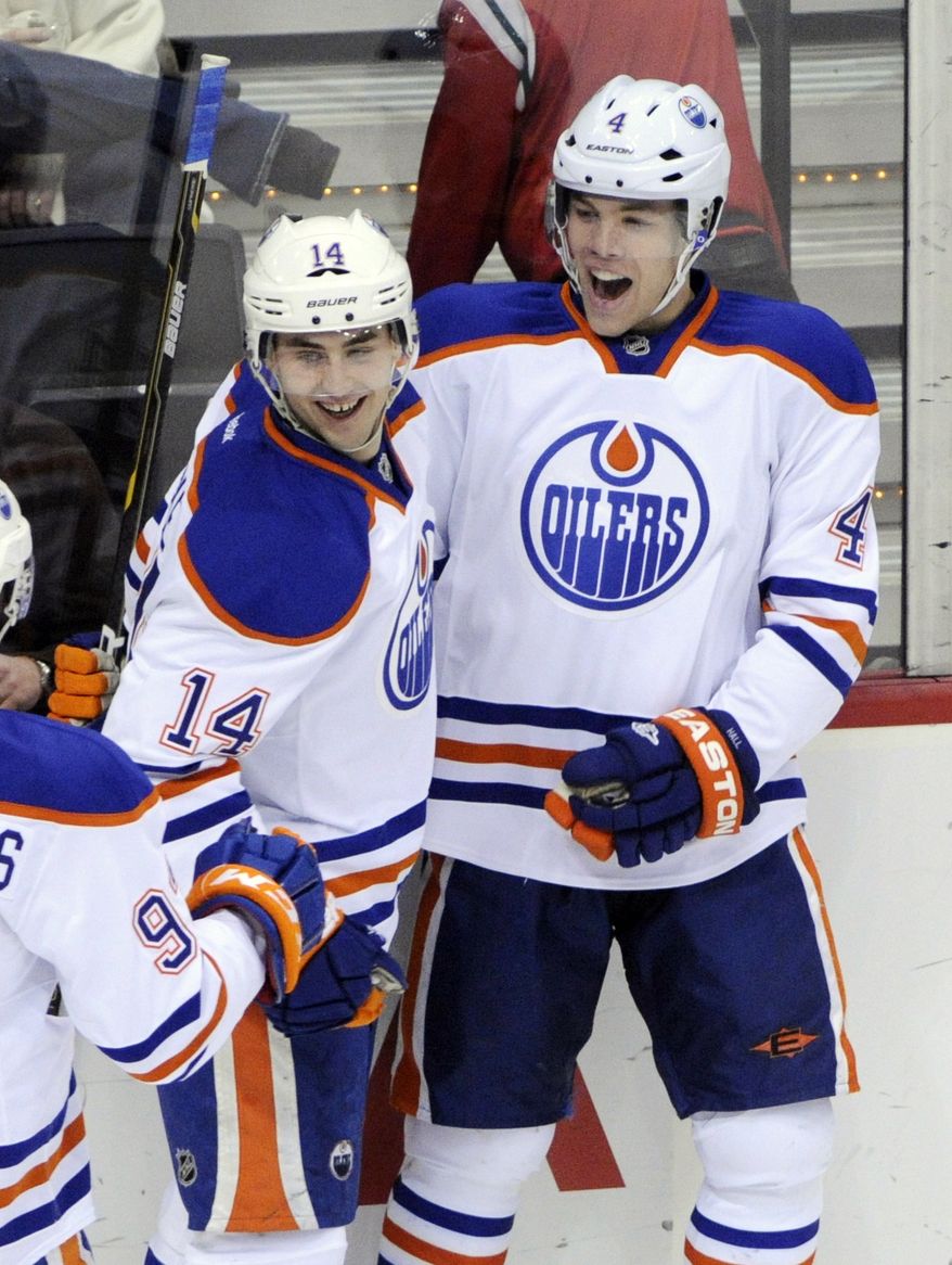 Edmonton Oilers' Jordan Eberle, left, celebrates with Taylor Hall following Hall's goal off Minnesota Wild goalie Niklas Backstrom, of Finland, in the first period of an NHL hockey game Thursday, Dec. 29, 2011, in St. Paul, Minn. (AP Photo/Jim Mone)