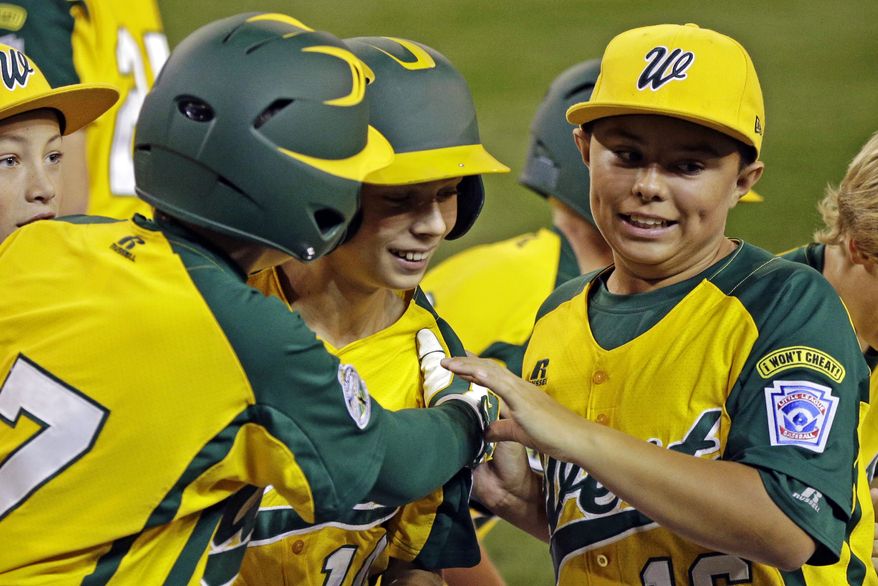 Petaluma, Calif.'s Hance Smith, center, is greeted by Blake Buhrer, left, and Andrew White, right, after hitting a three-run home run off Fairfield, Conn., pitcher Matt Kubel in the third inning of an elimination baseball game at the Little League World Series tournament in South Williamsport, Pa., Tuesday, Aug. 21, 2012. Petaluma won 5-0. (AP Photo/Gene J. Puskar)
