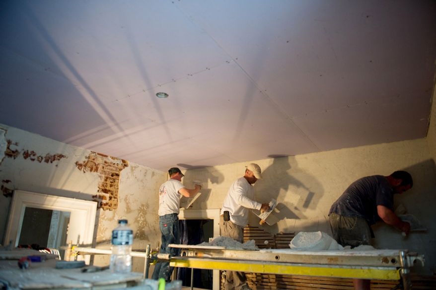 Restoration masons Justin Rivenburgh, left, Tim Winther, center, and Adam Shehan, right, work to repair the historic Cuckoo house, built by the Pendleton family in 1819 just outside Mineral Va. (Andrew Harnik/The Washington Times)