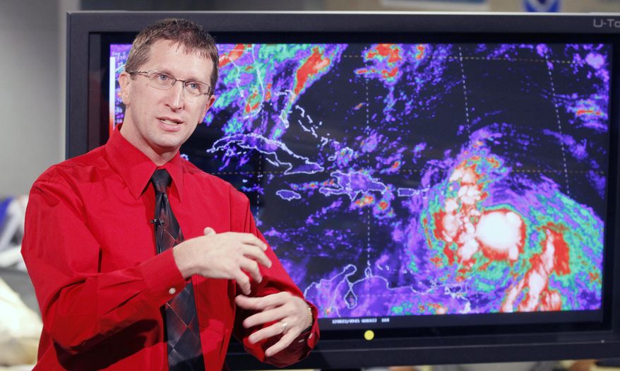 Rick Knabb, director of the National Hurricane Center, updates a reporter on Tropical Storm Isaac on Wednesday, Aug. 22, 2012, in Miami. The agency said Isaac was expected to strengthen and could become a hurricane by Thursday. (AP Photo/Alan Diaz)