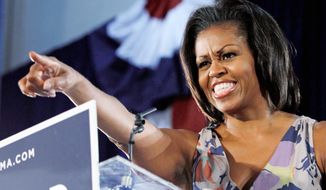First lady Michelle Obama points to supporters at the War Memorial Auditorium in Fort Lauderdale, Fla., on Wednesday, Aug. 22, 2012. (Associated Press)
