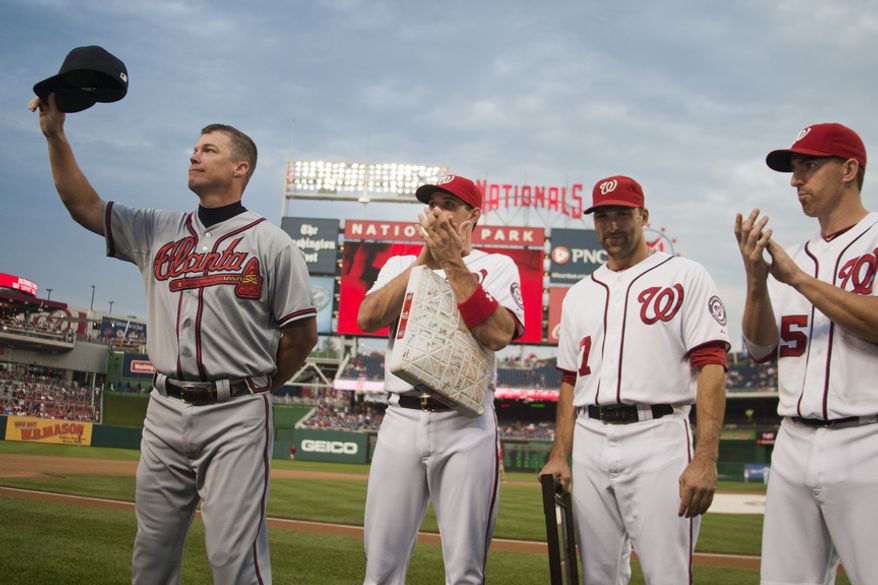 Washington Nationals Ryan Zimmerman, Mark DeRosa and Adam LaRoche present gifts to Chipper Jones, Wednesday, Aug. 22, 2012, in Washington, DC. Jones said he would be retiring after this session. He has played his entire 19 year career was an Atlanta Brave, winning one World Series title with them in 1995. (Craig Bisacre/The Washington Times)