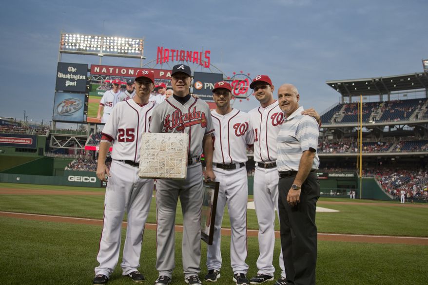 Washington Nationals, Adam LaRoche, Mark DeRosa, Ryan Zimmerman and General Manager Mike Rizzo, present gifts to Chipper Jone, Wednesday, Aug. 22, 2012, in Washington, DC. Jones said he would be retiring after this session. He has played his entire 19 year career was an Atlanta Brave, winning one World Series title with them in 1995. (Craig Bisacre/The Washington Times)