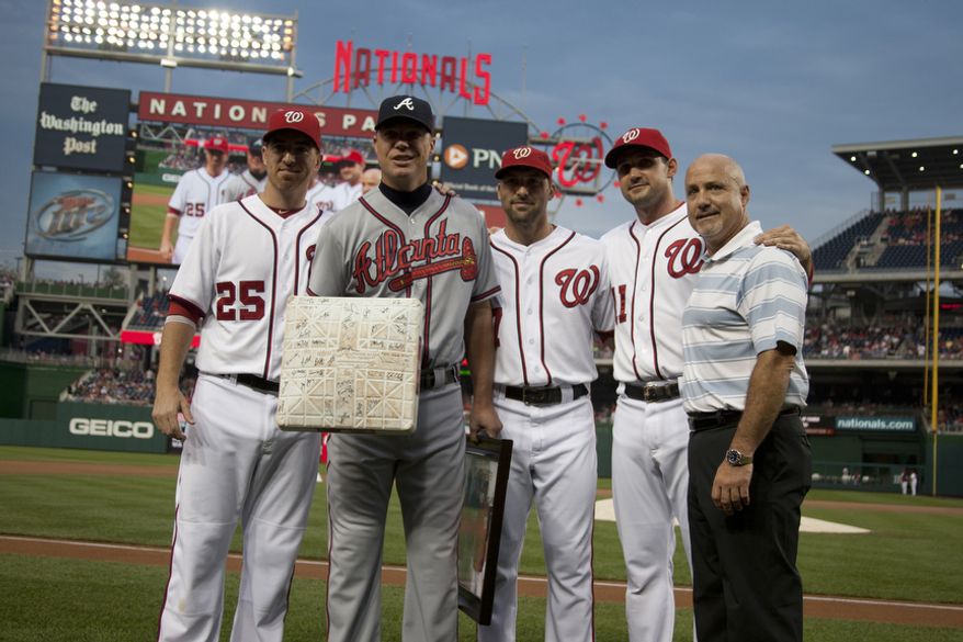 Washington Nationals, Adam LaRoche, Mark DeRosa, Ryan Zimmerman and General Manager Mike Rizzo, present gifts to Chipper Jone, Wednesday, Aug. 22, 2012, in Washington, DC. Jones said he would be retiring after this session. He has played his entire 19 year career was an Atlanta Brave, winning one World Series title with them in 1995. (Craig Bisacre/The Washington Times)
