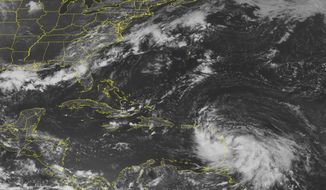 Tropical Storm Isaac, in the lower right corner, moves over the Lesser Antilles in a satellite image from the National Oceanic and Atmospheric Administration taken on Wednesday, Aug. 22, 2012, at 1:45 p.m. EDT. (AP Photo/Weather Underground)