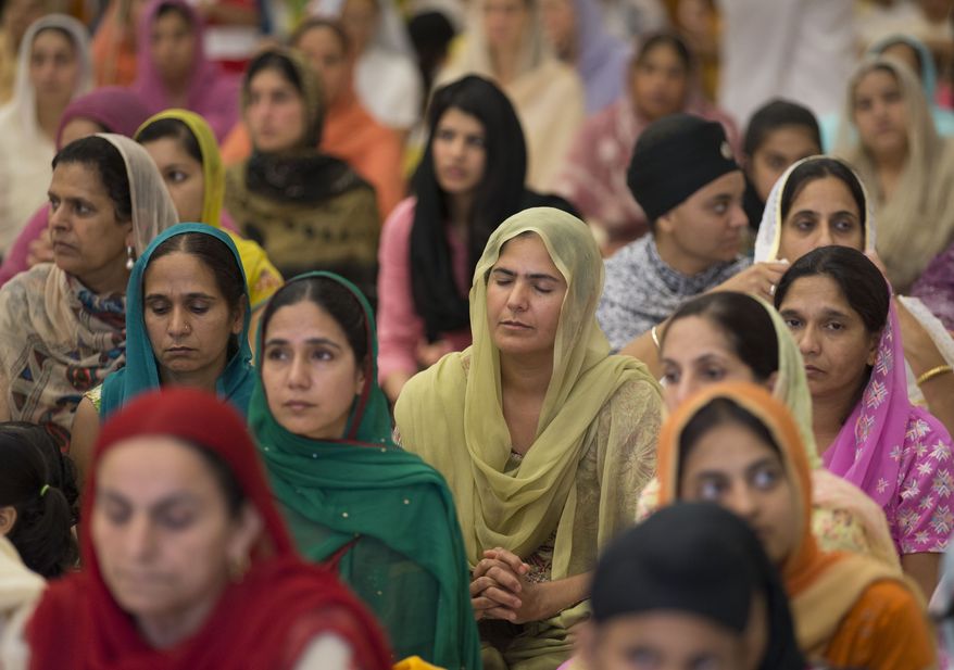 More than 100 people gather for a prayer service at the Sikh Temple of Wisconsin in Oak Creek, Wis., on Sunday, Aug. 12, 2012. (AP Photo/Jeffrey Phelps)