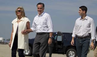Republican presidential candidate, former Massachusetts Gov. Mitt Romney, center, and his wife Ann, arrive at the Oakland County International Airport with vice presidential running mate Rep. Paul Ryan, R-Wis., on Friday, Aug. 24, 2012 in Waterford, Mich. (AP Photo/Evan Vucci)