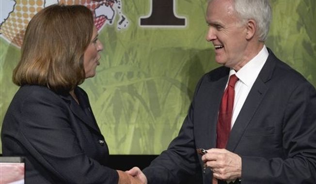 **FILE** Deb Fischer (left), the Republican candidate for the Nebraska Senate seat, shakes hands with her Democratic counterpart Bob Kerrey following their first debate at the Nebraska state fair in Grand Island, Neb., on Aug. 25, 2012. The two are vying for the Senate seat of Democrat Ben Nelson, who is not seeking re-election. (Associated Press)