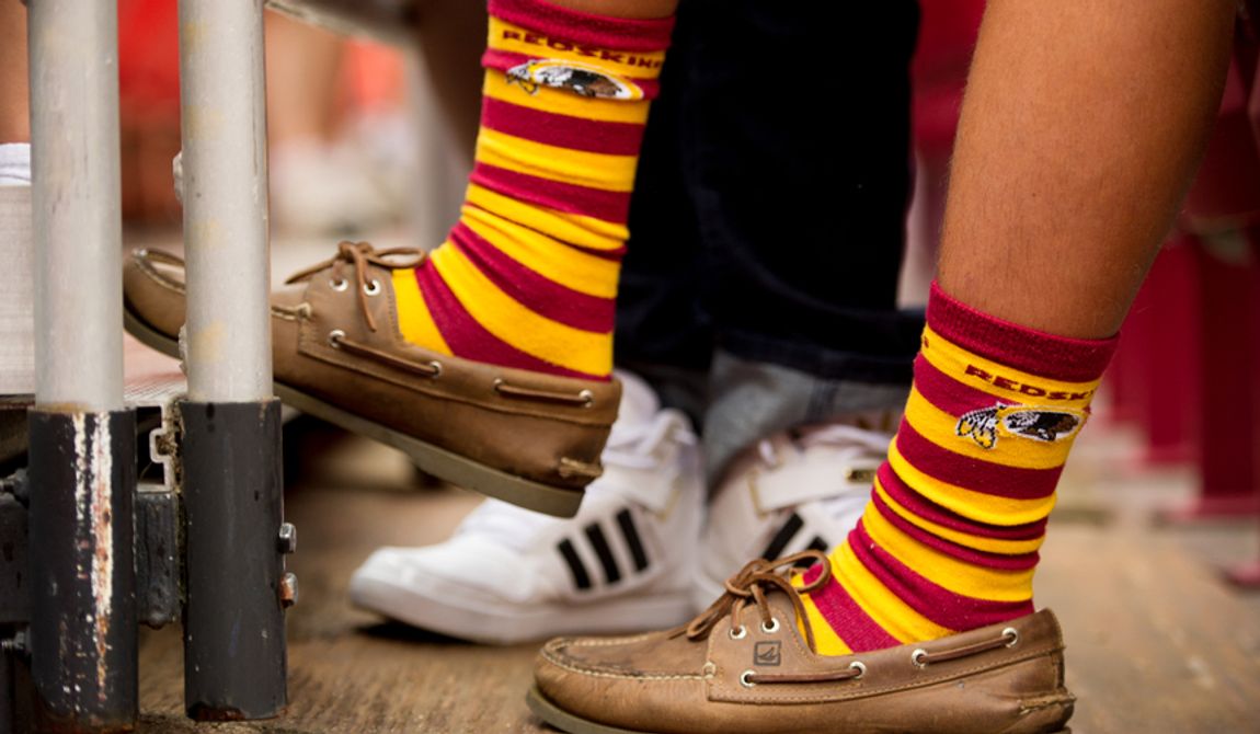 A Washington Redskins fan wears redskins sox as the Washington Redskins take on the Indianapolis Colts in NFL preseason football at FedEx Field, Landover, Md., Saturday, August 25, 2012. Washington Redskins quarterback Robert Griffin III (10) has become known for wearing unique sox. (Andrew Harnik/The Washington Times)