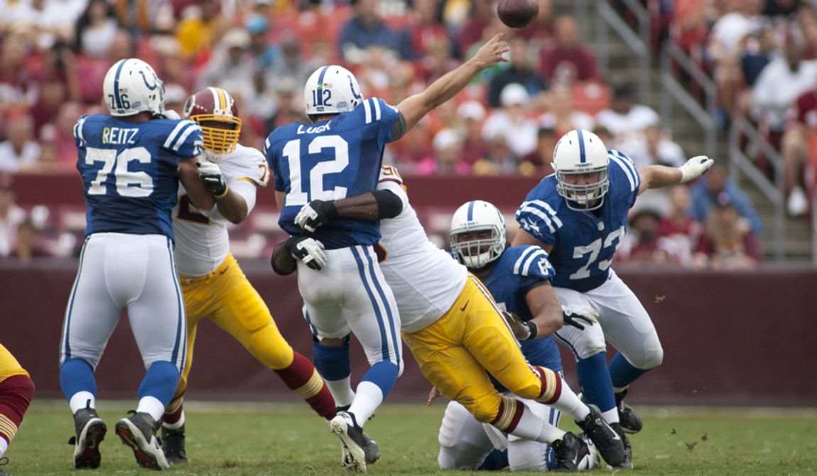 Indianapolis Colts quarterback Andrew Luck (12) is hit hard during first half action of the Indianapolis Colts at Washington Redskins preseason football game, Saturday, August 25, 2012 in Washington, DC. (Craig Bisacre/The Washington Times) 