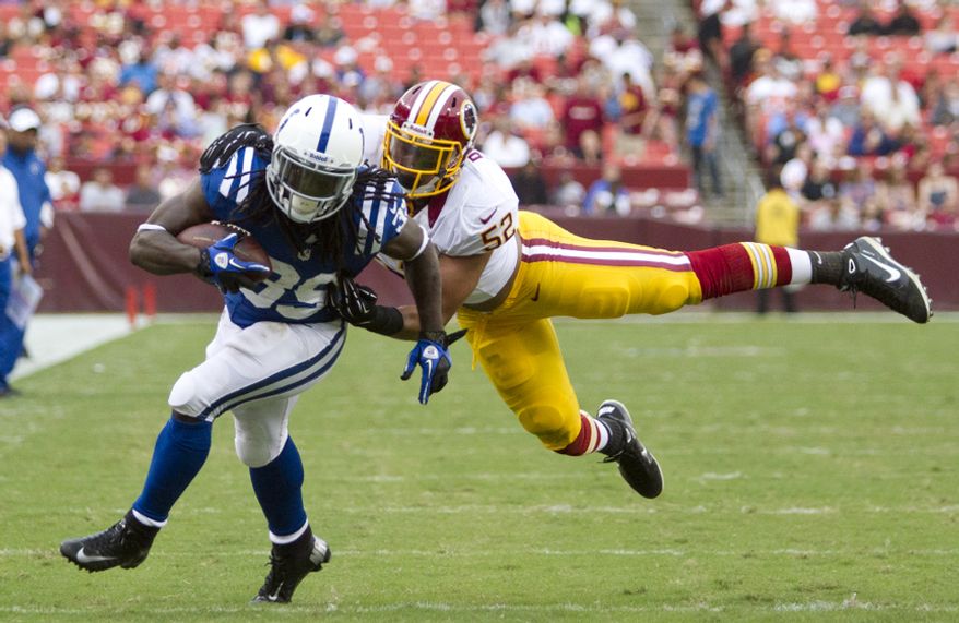 Washington Redskins linebacker Keenan Robinson (52) tackles Indianapolis Colts cornerback Cameron Chism (39) before he could reach the end zone in second half action of the Indianapolis Colts at Washington Redskins preseason football game, Saturday, August 25, 2012 in Washington, DC. (Craig Bisacre/The Washington Times)