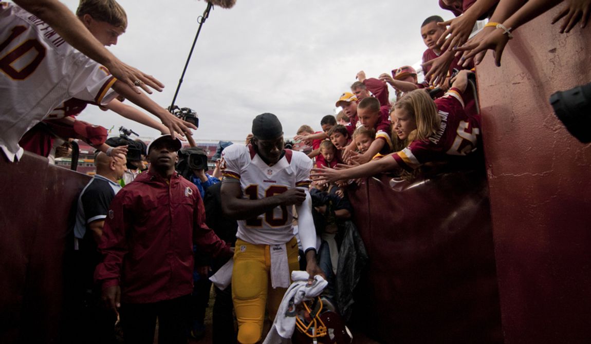 Fans try to touch Washington Redskins quarterback Robert Griffin III (10) as he leaves the field at the end of the Indianapolis Colts at Washington Redskins preseason football game, Saturday, August 25, 2012 in Washington, DC. Redskins won 30 - 17. (Craig Bisacre/The Washington Times)