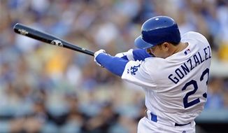Los Angeles Dodgers&#39; Adrian Gonzalez swings on a three-run home run during the first inning of a baseball game against the Miami Marlins, Saturday, Aug. 25, 2012, in Los Angeles. (AP Photo/Mark J. Terrill)
