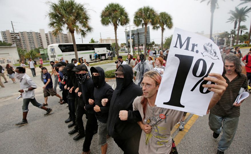 Demonstrators march in downtown St. Petersburg, Fla. The protestors were demonstrating outside Tropicana Field where a welcoming event is taking place for the delegates of the Republican National Convention (AP Photo/Dave Martin)