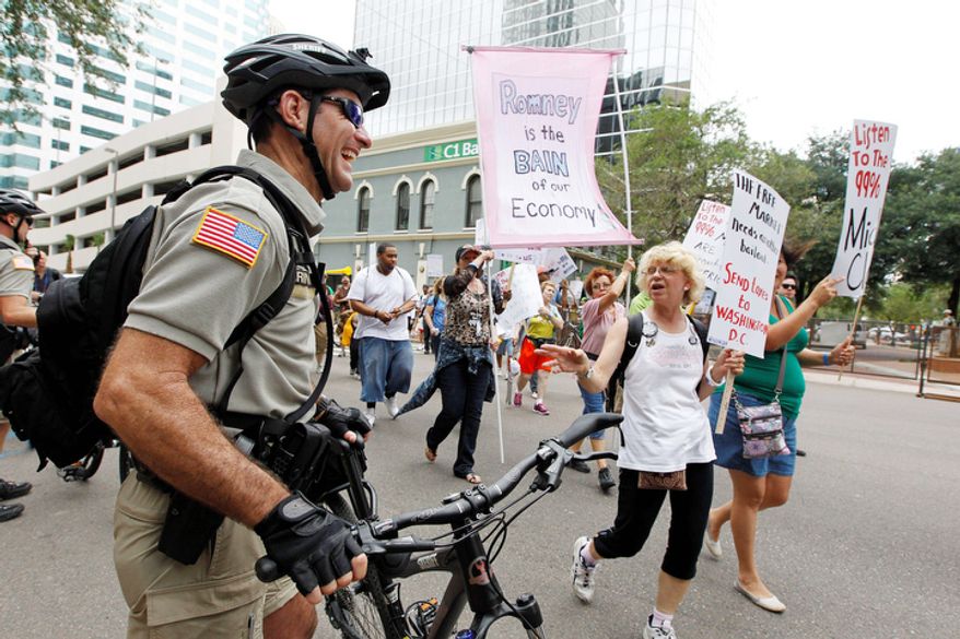 A demonstrator speaks to a police officer during a protest march in Tampa, Fla. (AP Photo/Chris O'Meara)