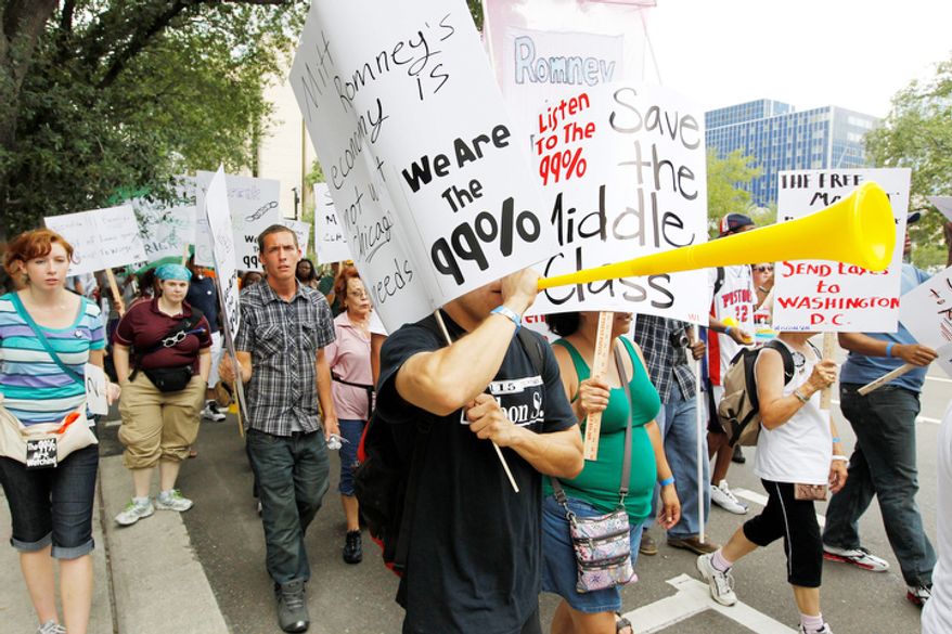 Demonstrators walk with others during a protest march in Tampa, Fla. Hundreds of protestors gathered in Gas Light Park in downtown Tampa to march in demonstration against the Republican National Convention. (AP Photo/Chris O'Meara)