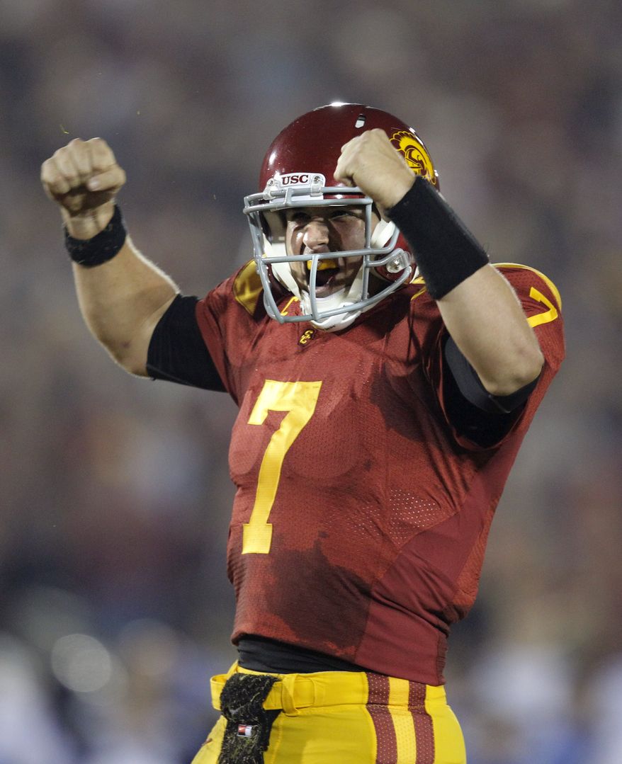 FILE - In this Nov. 26, 2011 file photo, Southern California quarterback Matt Barkley celebrates a touchdown by teammate Rhett Ellison during the first half of an NCAA college football game against UCLA in Los Angeles. USC is ranked No. 1 in the Associated Press preseason college football poll released on Saturday, Aug. 18, 2012. (AP Photo/Jae Hong, File)