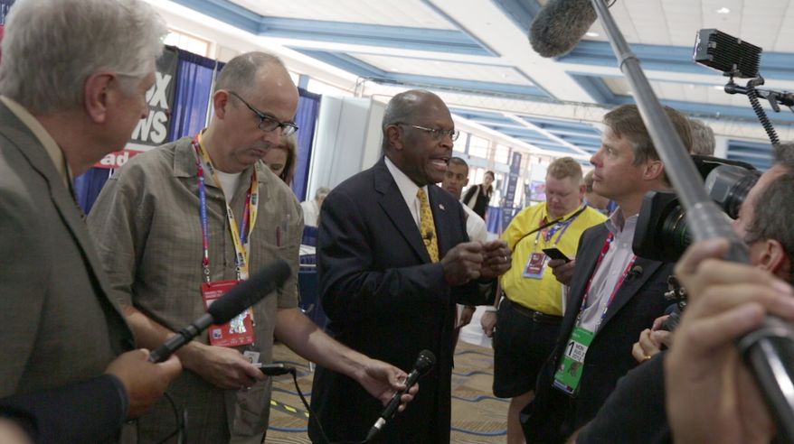 Herman Cain talks with reporters at the National Republican Convention (RNC), in Tampa, FL., Monday, August 27, 2012. The RNC will run from the 27th through the 30th of August.(Andrew S. Geraci/The Washington Times)