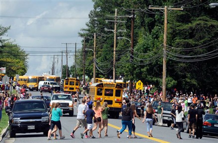 Parents and students try to reunite after a student was shot and critically wounded on the first day of classes at Perry Hall High School, Monday, Aug. 27, 2012, in Perry Hall, Md. A suspect was taken into custody shortly after the shooting, according to police. No one else was reported injured. (AP Photo/Steve Ruark)