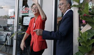 Massachusetts Senate candidate Elizabeth Warren waves Aug. 23, 2012, as she campaigns in Methuen, Mass. She is accompanied by Methuen Mayor Stephen Zanni. (Associated Press)