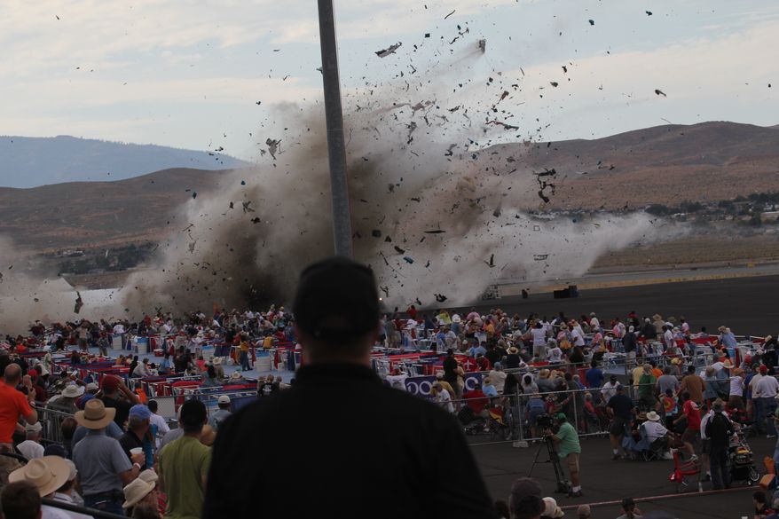 FILE - In this Sept. 16, 2011 file photo, A P-51 Mustang airplane crashes into the edge of the grandstands at the Reno Air show in Reno, Nev, leaving 11 people dead and 70 seriously injured. The National Transportation Safety Board, meeting in Washington, will determine the cause of the September 2011 crash of a modified World War II-era fighter plane into a spectator area during the 2011 National Championship Air Races in Reno on Monday, Aug. 27, 2012. (AP Photo/Ward Howes, File)