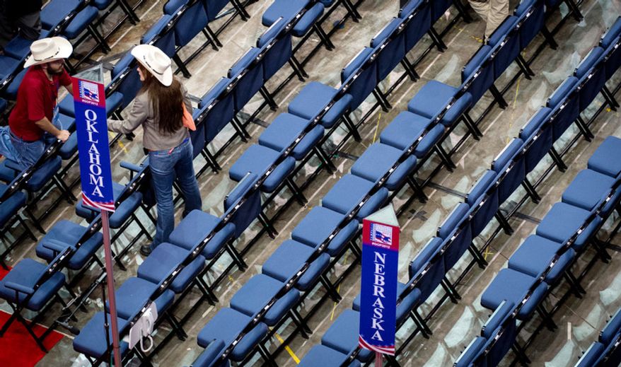 Delegates talk on the floor of the Republican National Convention after Chairman of the Republican National Committee Reince Priebus calls a recess on the first day of events because of Hurricane Isaac. (Andrew Harnik/The Washington Times)