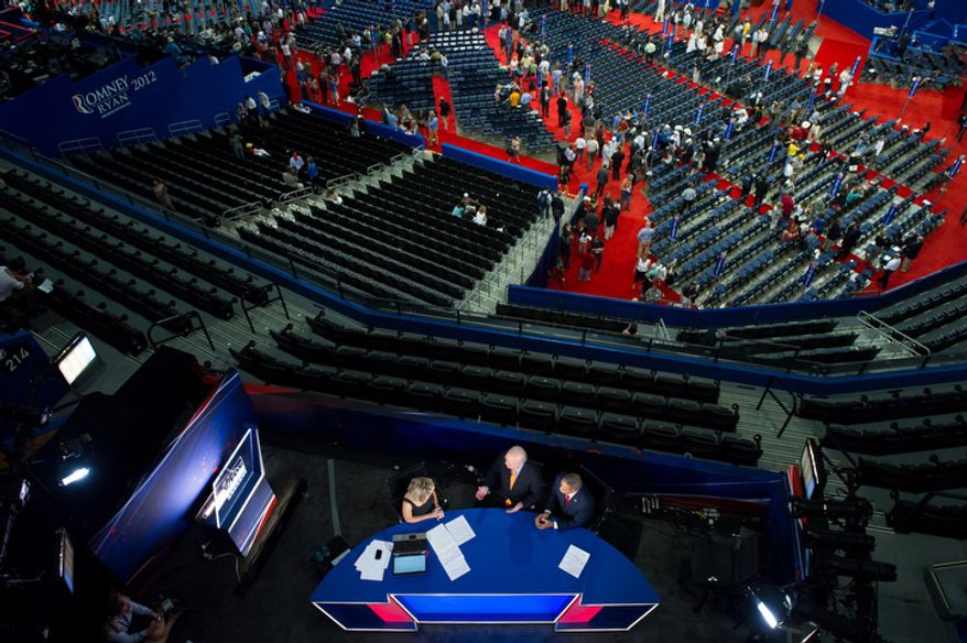Karl Rove, center, speaks on FOX News at the Republican National Convention after Chairman of the Republican National Committee Reince Priebus calls a recess on the first day of events because of Hurricane Isaac. (Andrew Harnik/The Washington Times)