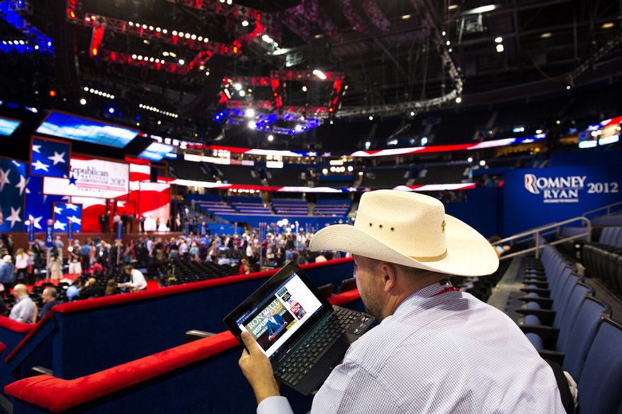 Toby Olin, of New Salem, N.D. watches a Ron Paul speech on his laptop near the Republican National Convention floor after Chairman of the Republican National Committee Reince Priebus calls a recess on the first day of events. (Andrew Harnik/The Washington Times)