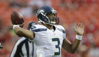 Seattle Seahawks quarterback Russell Wilson (3) passes to a teammate during the first half of an NFL preseason football game against the Kansas City Chiefs in Kansas City, Mo., Friday, Aug. 24, 2012. (AP Photo/Charlie Riedel)