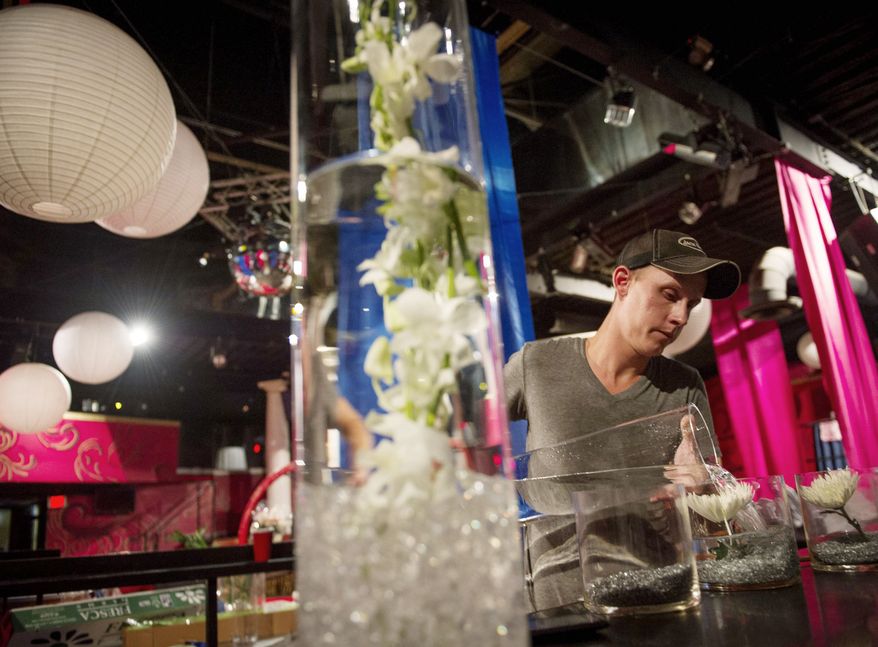 Mathieu Stanch works to prepare decorations for a Homocon 2012 party at the Honey Pot club during the Republican National Convention in Tampa, Fla. The event is intended to spotlight the mutual interests of gay Republicans and GOProud movement conservatives. (Rod Lamkey Jr./The Washington Times)