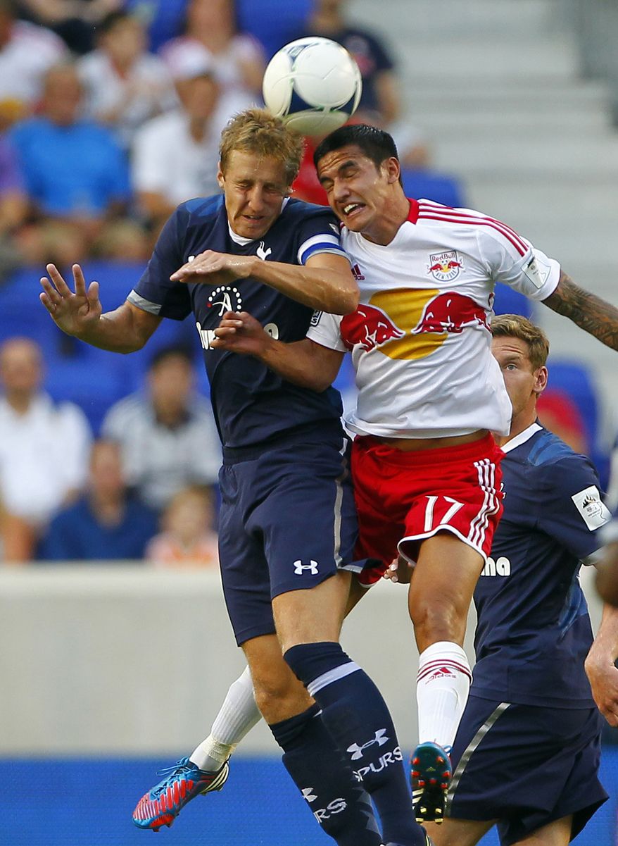 Tottenham Hotspur's Michael Dawson (20) battles New York Red Bulls' Tim Cahill (17) for a header in the first half during a friendly soccer match at Red Bull Arena in Harrison, N.J., Tuesday, July 31, 2012. (AP Photo/Rich Schultz)