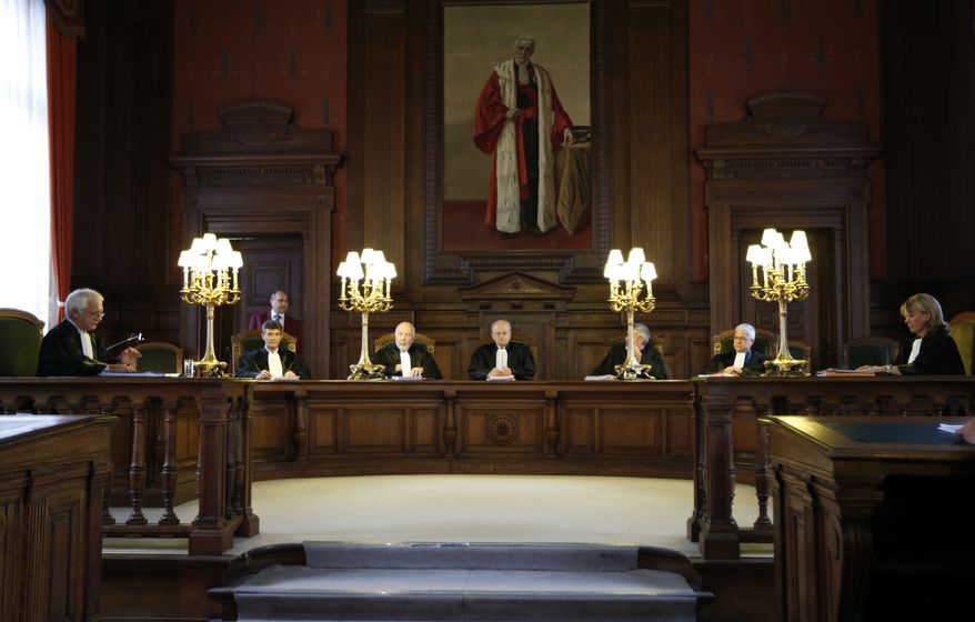 Judge Albert Fettweis (center) presides over a hearing for Michelle Martin at the Court of Cassation at the Justice Palace in Brussels on Tuesday, Aug. 28, 2012. Belgium's highest court granted conditional early release to Martin, one of the nation's most despised criminals, even though, as the accomplice and former wife of a pedophile and child killer, she let two of his victims starve to death. (AP Photo)