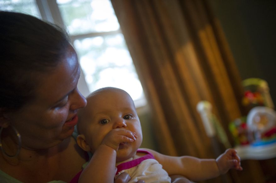 Sofia Carr are plays with her youngest daughter Olivia, 8 months after dinner at their home in Downingtown, Pa. (Rod Lamkey Jr./The Washington Times)