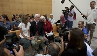 Cindy, center right, and Craig Corrie, center, the parents of Rachel Corrie, a pro-Palestinian activist who was killed by an Israeli bulldozer in Gaza in 2003, sit together with their daughter Sarah, center left, in the court room just before the district court&#39;s ruling in Haifa, Israel, Tuesday, Aug. 28, 2012. (AP Photo/Ariel Schalit)

