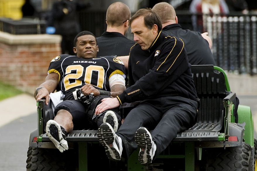 FILE - In this Nov. 12, 2011, file photo, Missouri tailback Henry Josey (20) is carted off the field under the supervision of team physician Pat Smith, right, after he injured his left knee during the third quarter of an NCAA college football game against Texas in Columbia, Mo. Head coach Gary Pinkel said on Monday, Aug. 27, 2012, that Josey will not play this upcoming season as he continues to recover from an injury that tore his ACL, MCL and patellar tendon. (AP Photo/L.G. Patterson, File)