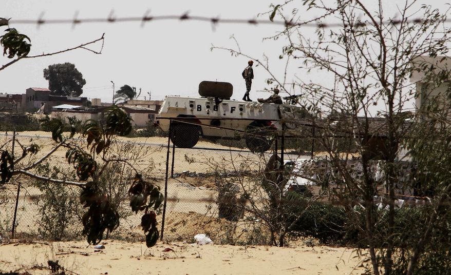 **FILE** Egyptian border guards patrol Aug. 6, 2012, near the border with Israel in Rafah, Egypt. President Mohammed Morsi is using former jhadists to mediate with radical Islamists in Sinai, trying to ensure a halt in militant attacks in return for a stop in a military offensive in the lawless peninsula, participants in the talks say. (Associated Press)