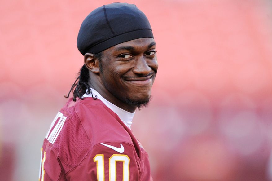 Washington Redskins quarterback Robert Griffin III (10) smiles during warmups at FedEx Field. (Preston Keres/Special to The Washington Times)