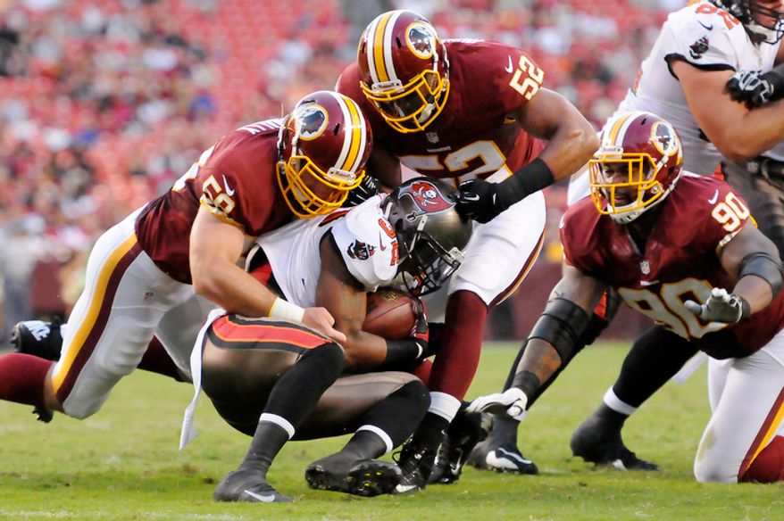 Tampa Bay Buccaneers running back Mossis Madu (32) is tackled for a loss by Washington Redskins Brian McNally (58) and Keenan Robinson (52) during first quarter action. (Preston Keres/Special to The Washington Times)