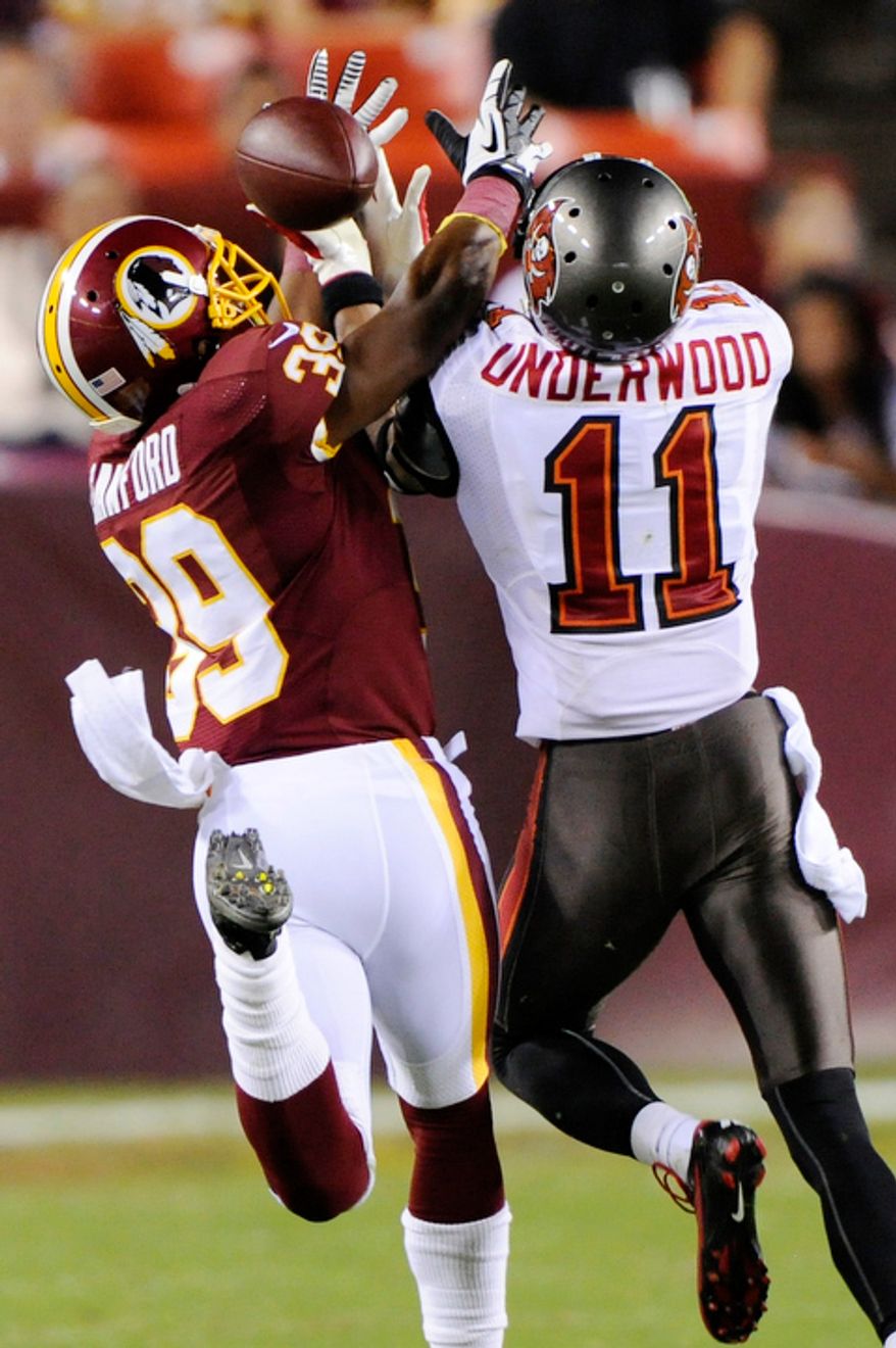 Washington Redskins cornerback Richard Crawford (39) intercepts a pass intended for Tampa Bay Buccaneers wide receiver Tiquan Underwood (11) during third quarter action. (Preston Keres/Special to The Washington Times)