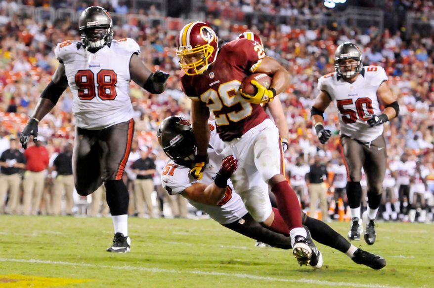 Washington Redskins running back Roy Helu (29) runs through Tampa Bay Buccaneers linebacker Jacob Cutrera (51) for a 6-yard touchdown run in the third quarter. (Preston Keres/Special to The Washington Times)