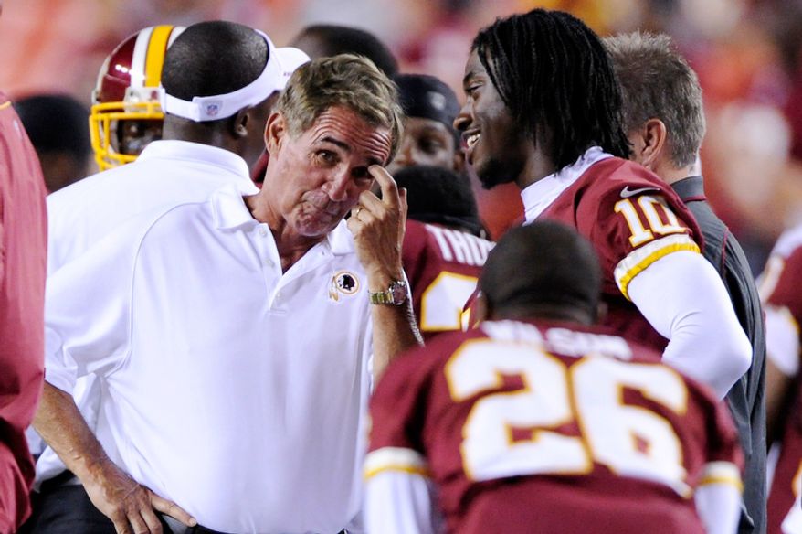 Washington Redskins head coach Mike Shanahan and quarterback Robert Griffin III (10) joke on the sidelines in the closing minutes of the game. (Preston Keres/Special to The Washington Times)