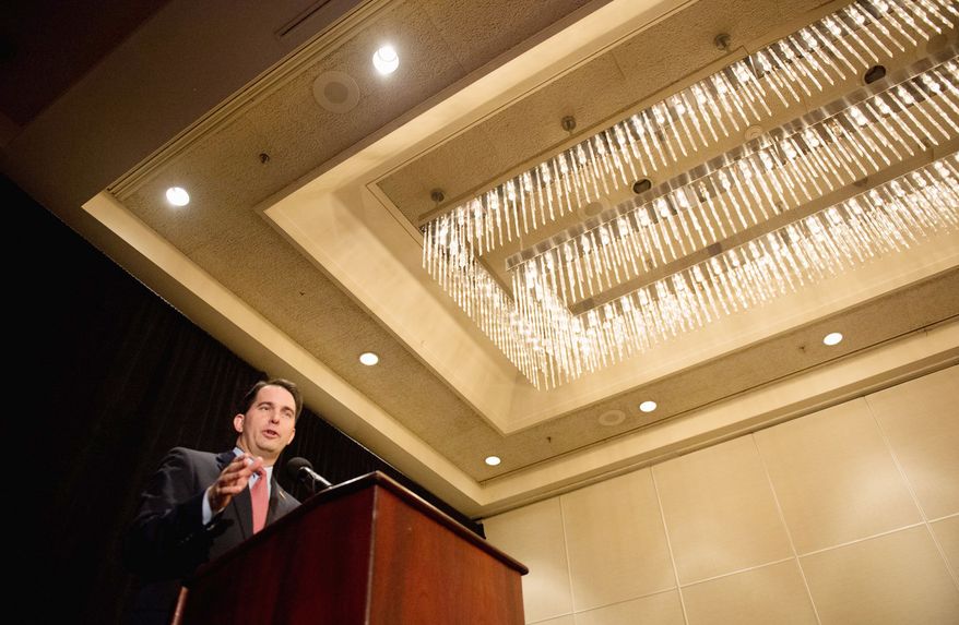 Wisconsin Gov. Scott Walker, who beat back a recall attempt in June, received one of the longest, sustained show of appreciation by the audience of any of the speakers at the Republican National Convention. (Andrew Harnik/The Washington Times)