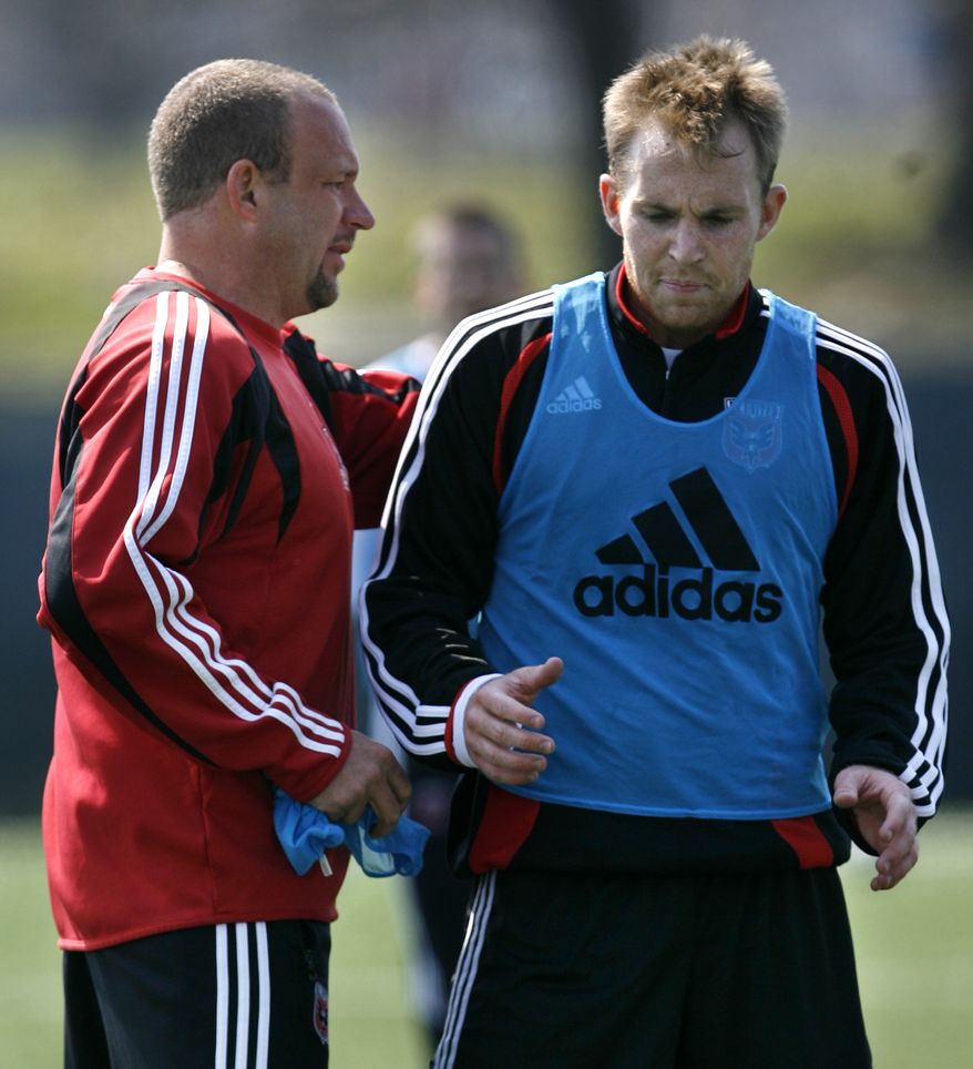 FILE - This March 22, 2007 file photo shows DC United head coach Thomas Soehn, left, talking with player Bryan Namoff at practice for the major league soccer team in Washington. Namoff has filed a $12 million lawsuit against the team and former coach Thomas Soehn, saying they rushed him back onto the field after the concussion that ultimately ended his career. (AP Photo/Jacquelyn Martin, File)